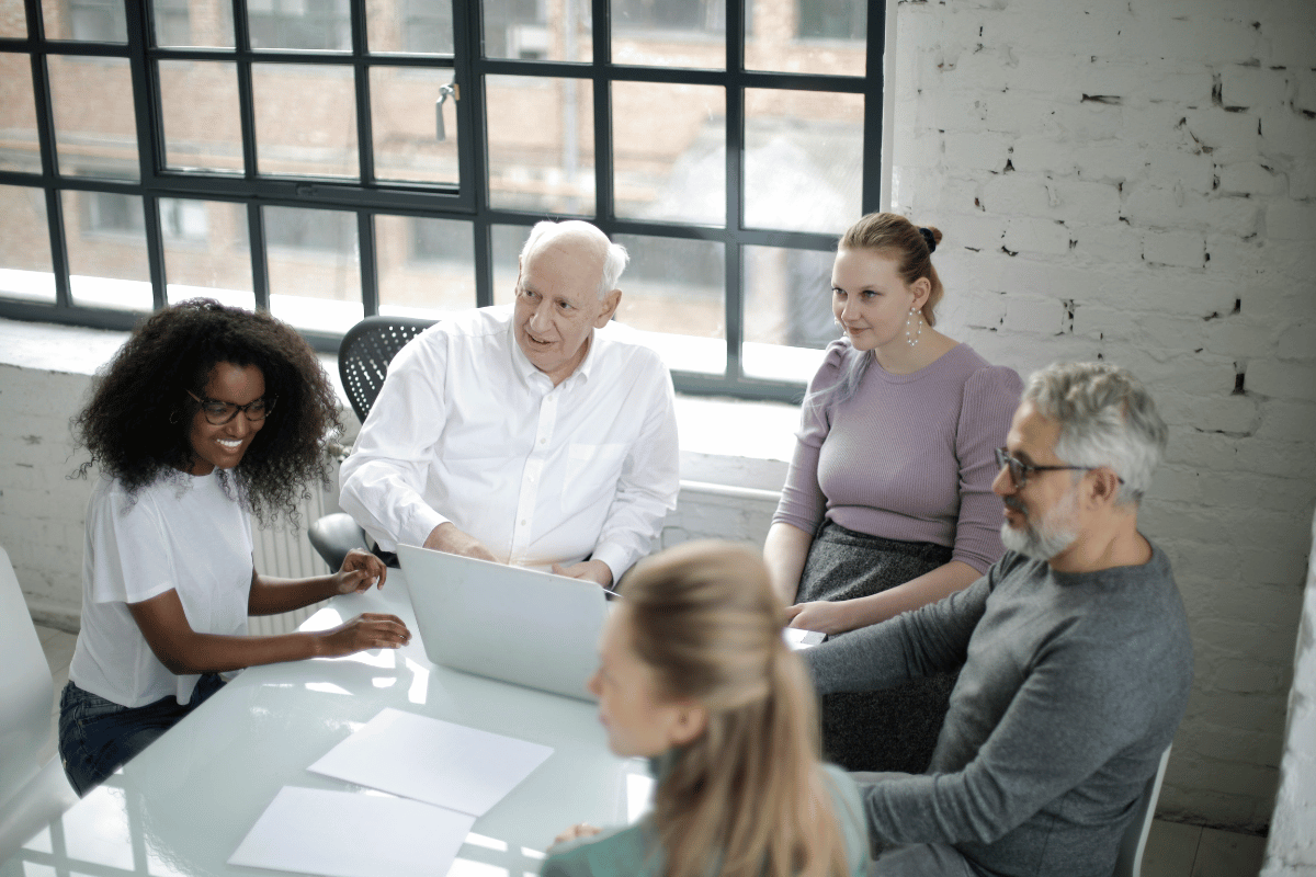 Team of diverse professionals discussing a project in a well-lit office.