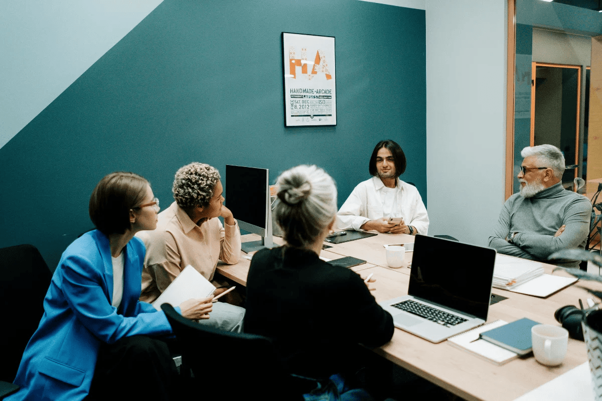 Diverse business team in a meeting with focus on strategic planning in a modern office setting.