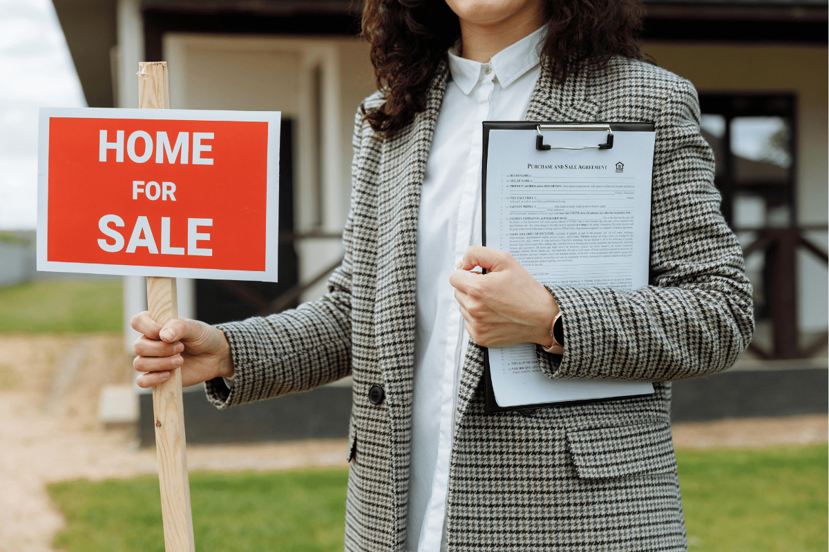 Real estate agent holds a "Home For Sale" sign and clipboard with documents, ready to make a deal.