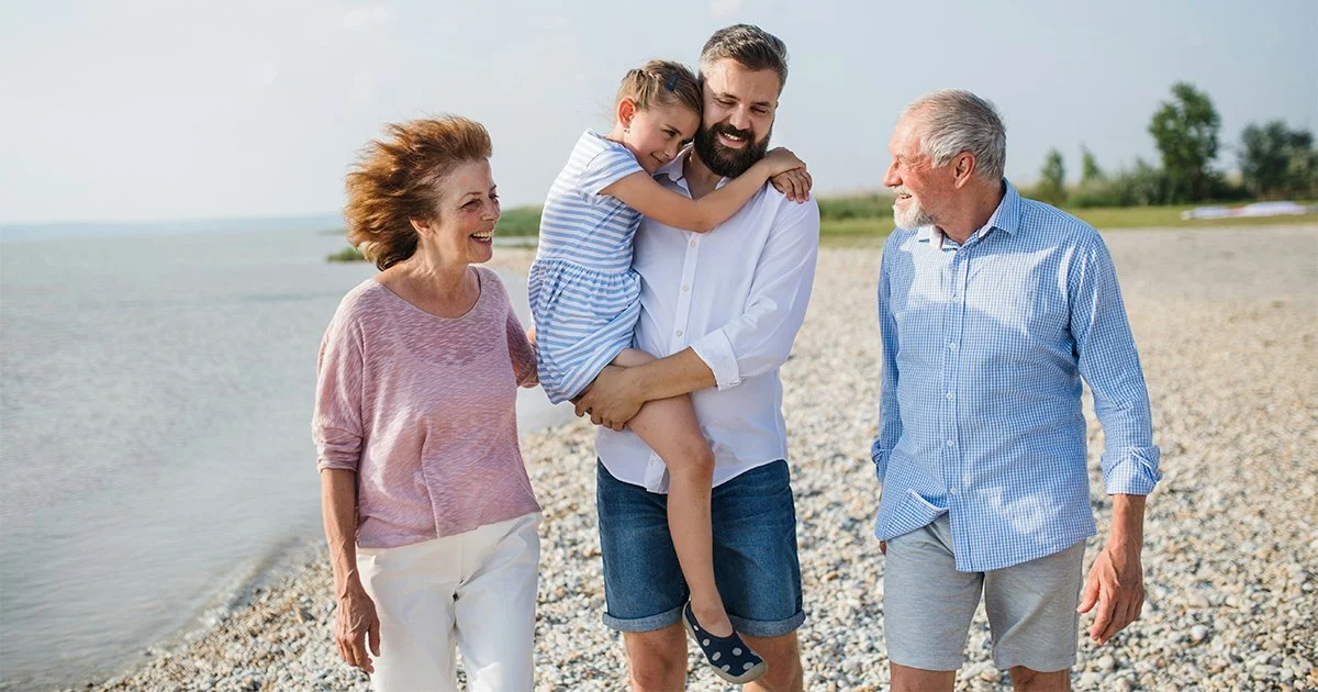 Capture the essence of generational wealth with this heartwarming image of a multi-generational family enjoying a day at the beach, symbolizing the lasting impact of high net worth estate planning on family unity and legacy.