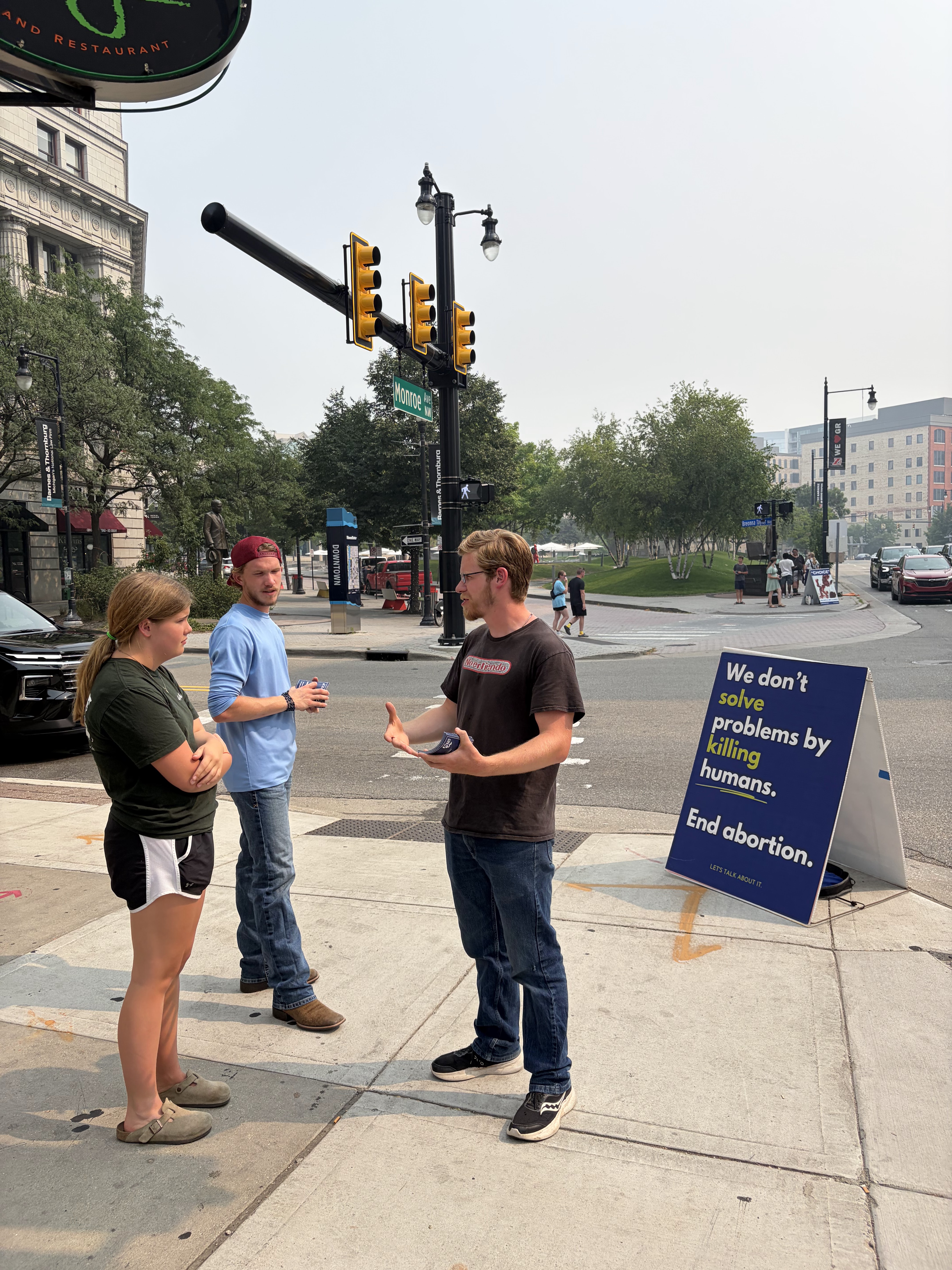Protect Life Michigan students in conversation about abortion on a sidewalk