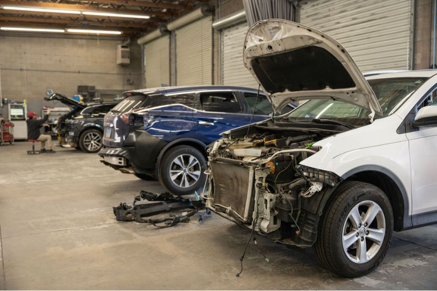 Family cars and SUVs in for collision repair at Spark Collision Center
