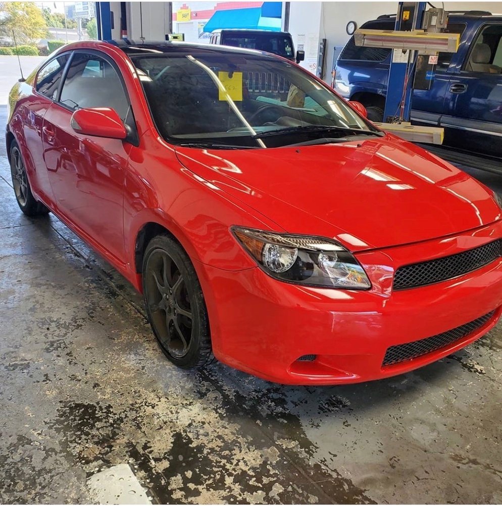 Freshly repaired red coupe ready for pickup
