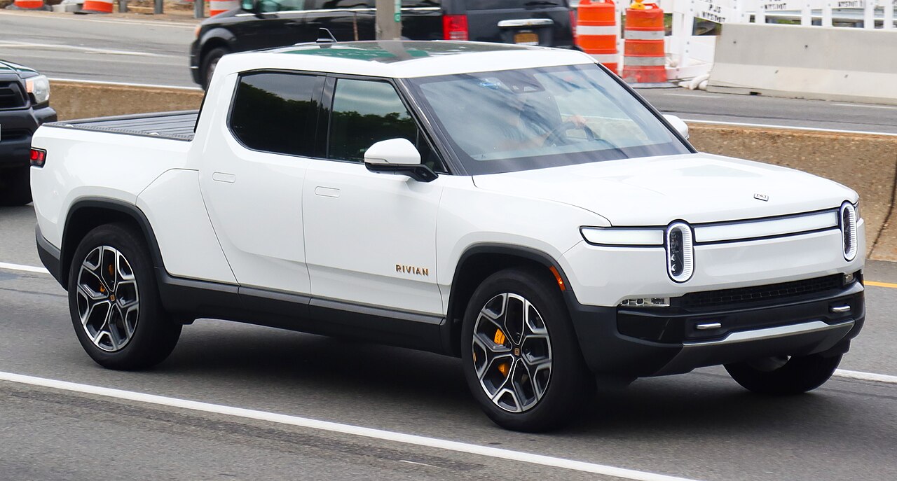 White Rivian R1T electric pickup truck, front three-quarter view