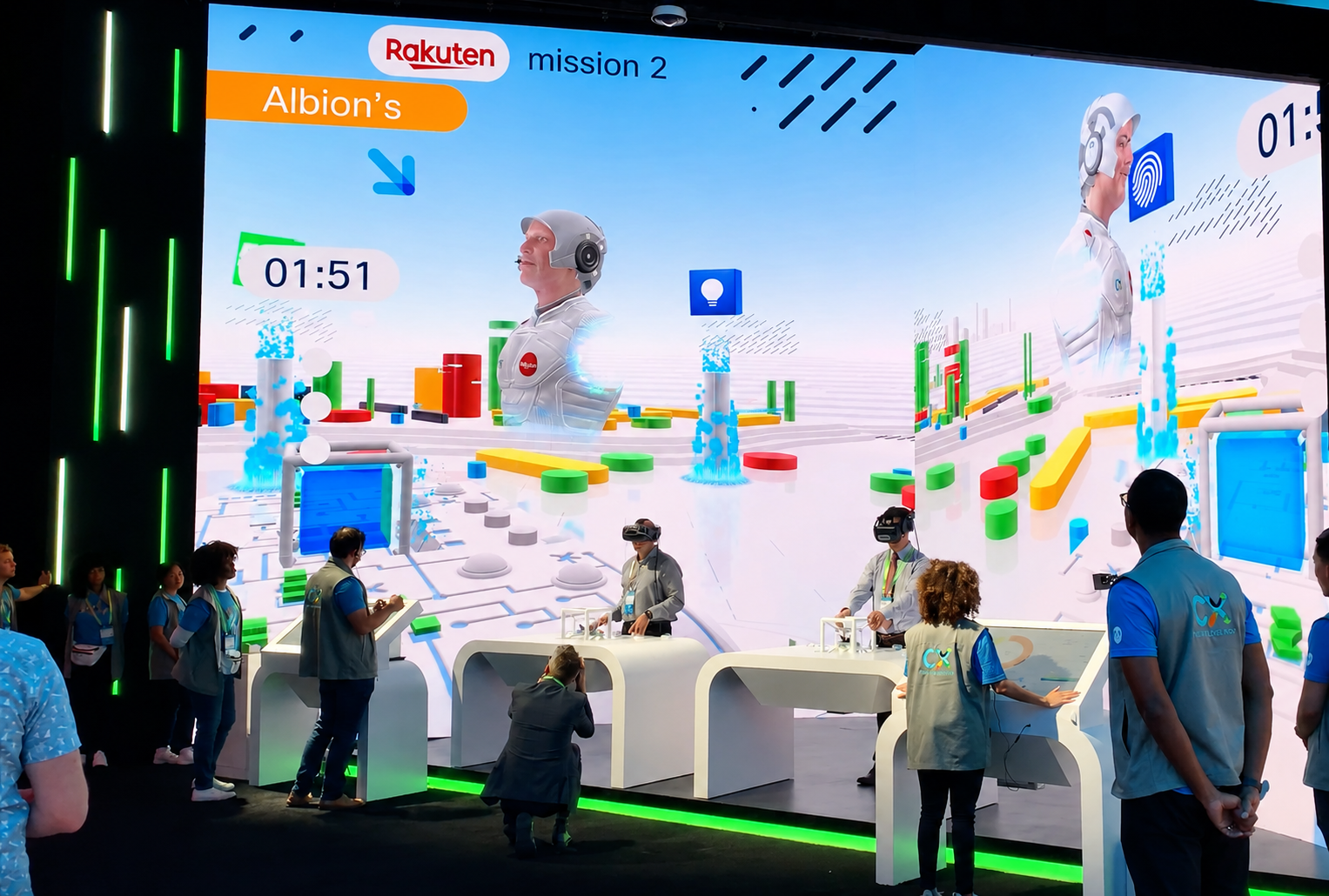 People wearing VR headsets interacting at white tables with a large colorful digital display behind them.