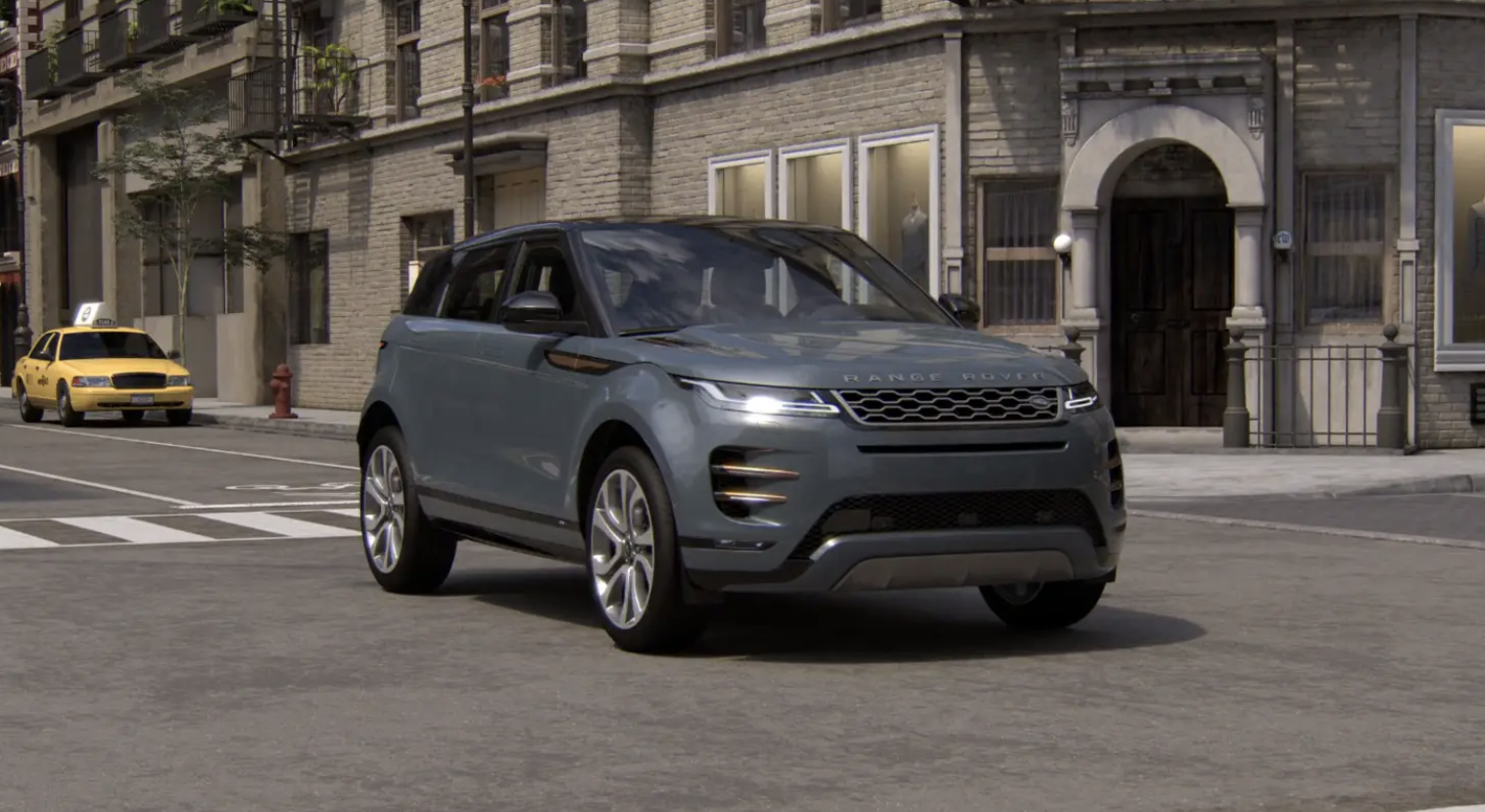 Grey Range Rover Evoque SUV parked on urban street with brick buildings and a yellow taxi in background.