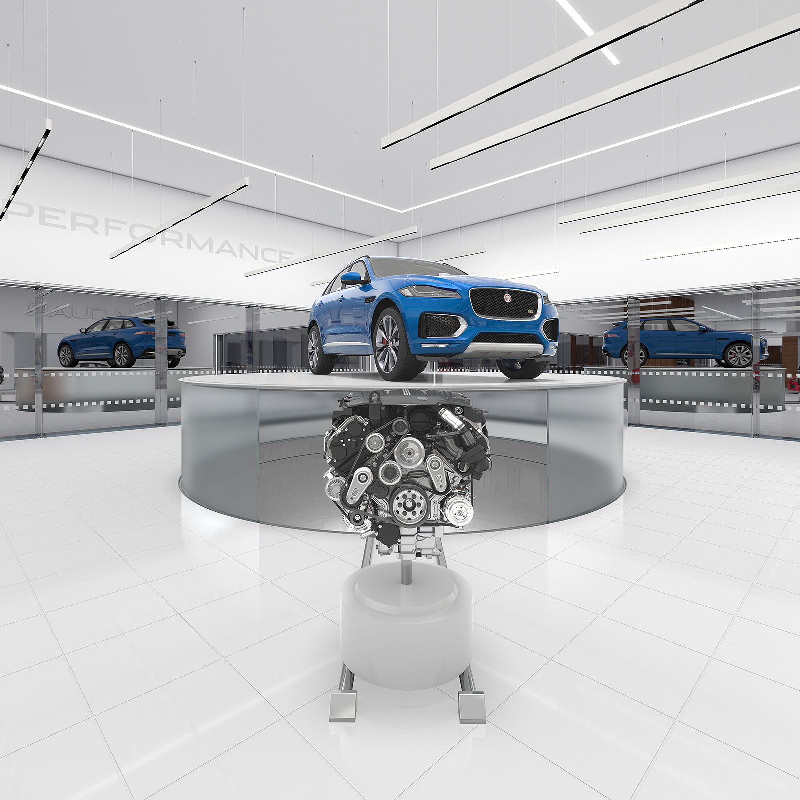 Blue Jaguar F-Pace SUV displayed on a round platform with an engine model in front in a modern showroom.