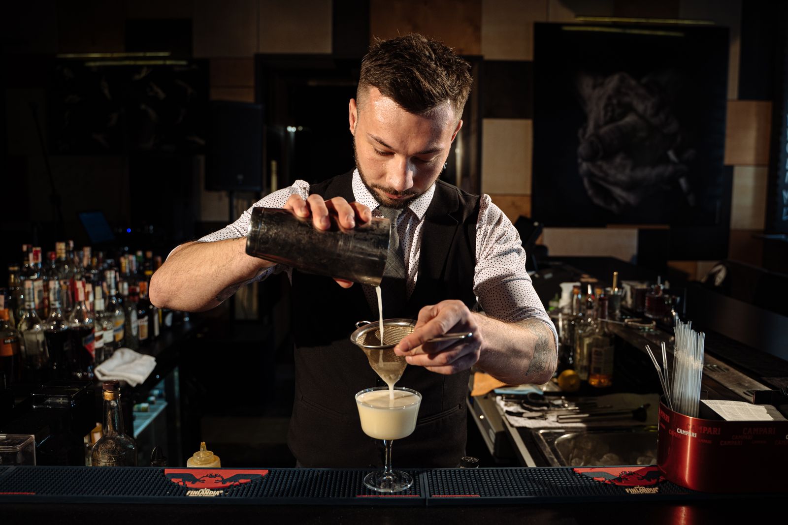 Bartender straining a freshly made cocktail at Gastro at 35