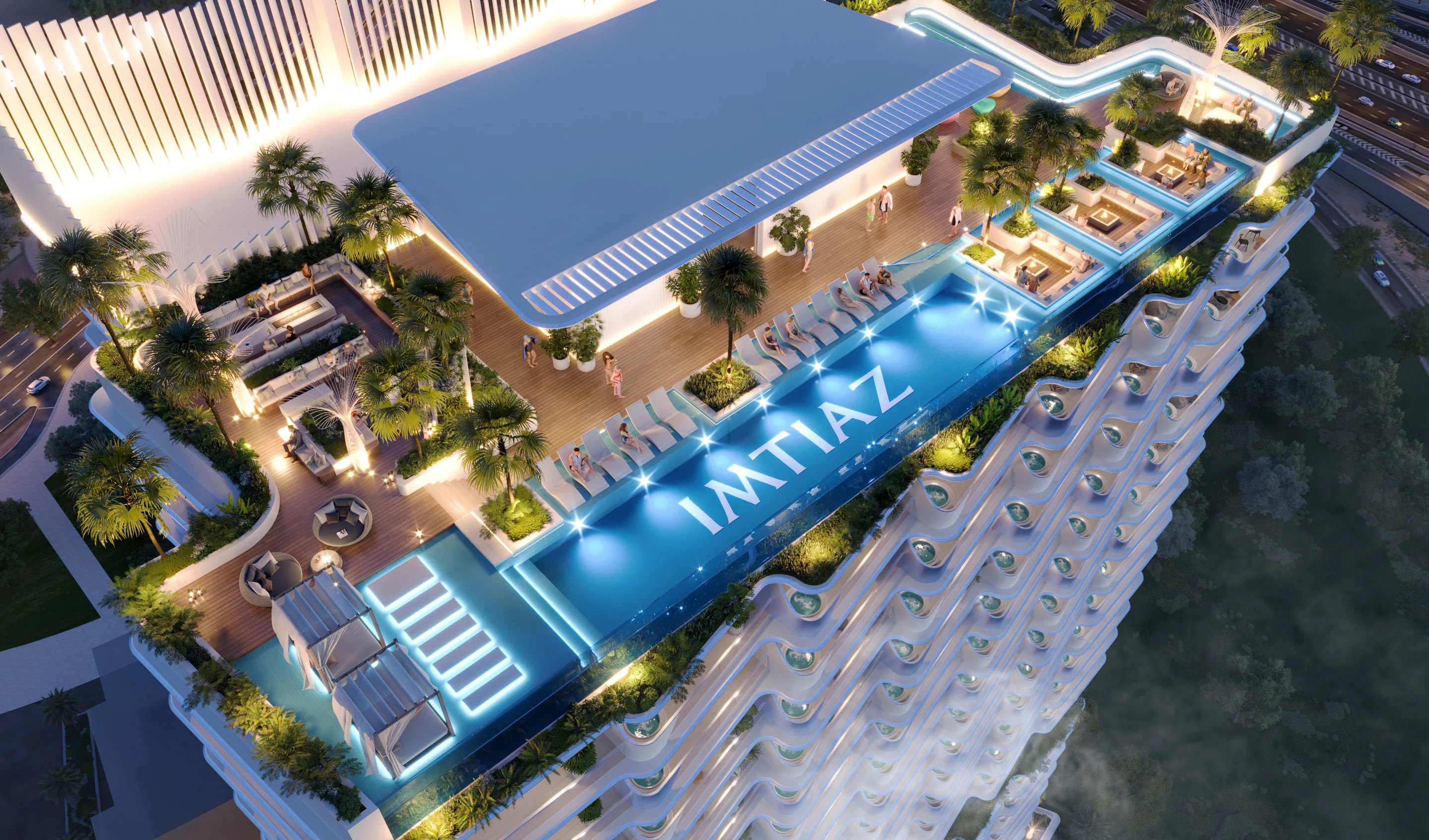 Elevated view of the illuminated pool and recreation deck