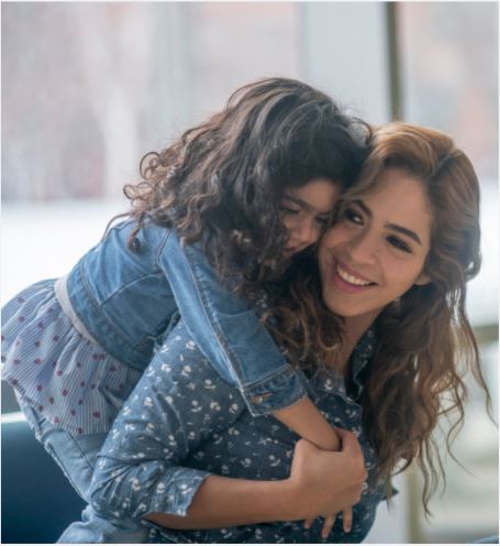 A mother hugs her daughter