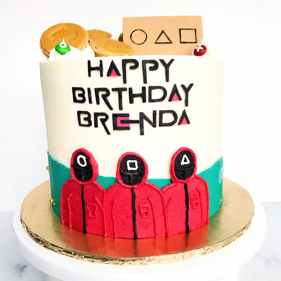 A themed birthday cake that reads Happy Birthday Brenda
