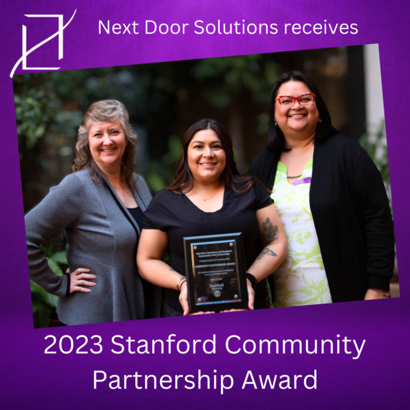 Three Next Door Solutions staff members holding the 2023 Stanford Community Partnership Award