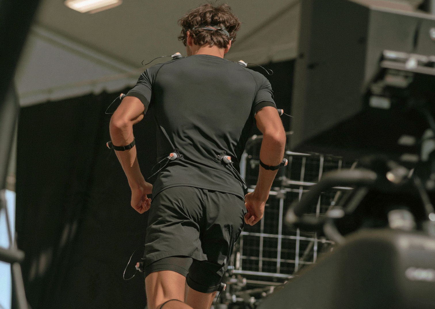 Athlete seen from behind wearing Xsens inertial sensors on arms, back and legs