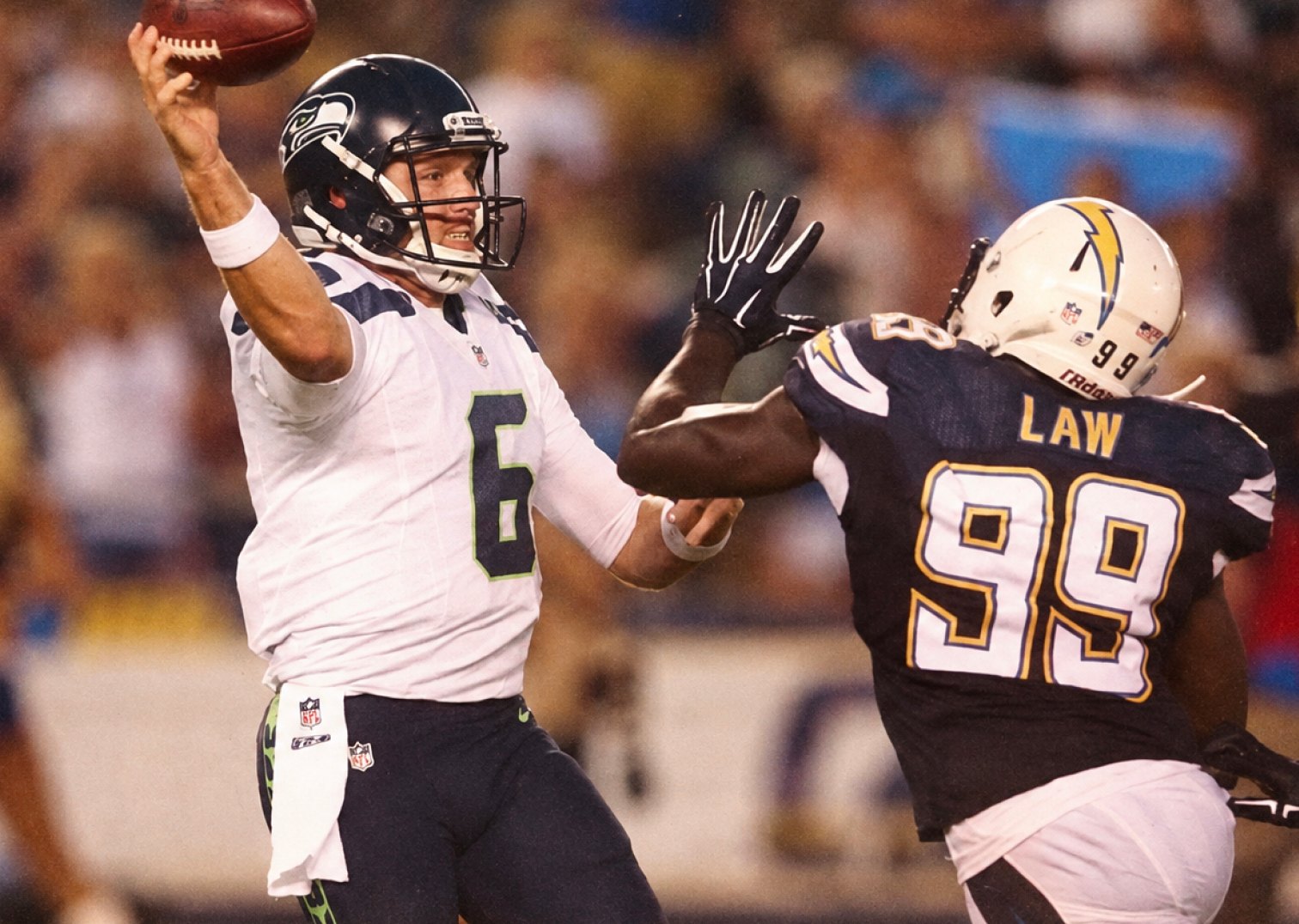R.J. Archer throwing a pass under pressure from a defender