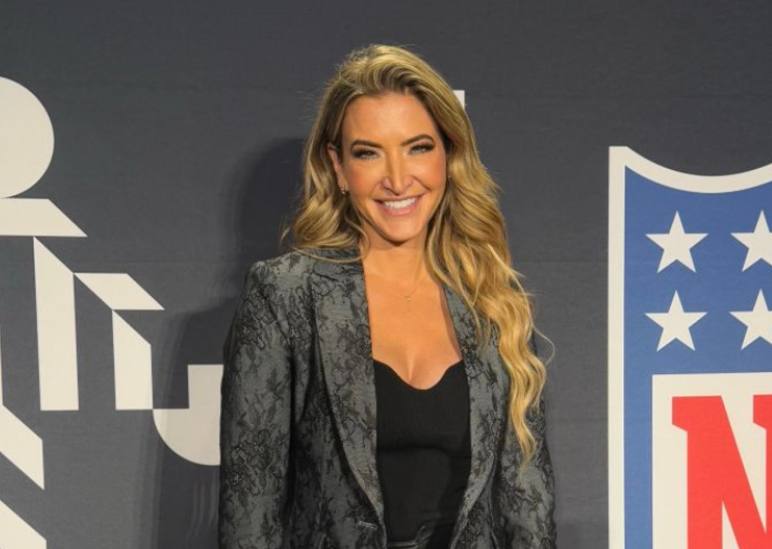 Cynthia Frelund in front of an NFL logo backdrop