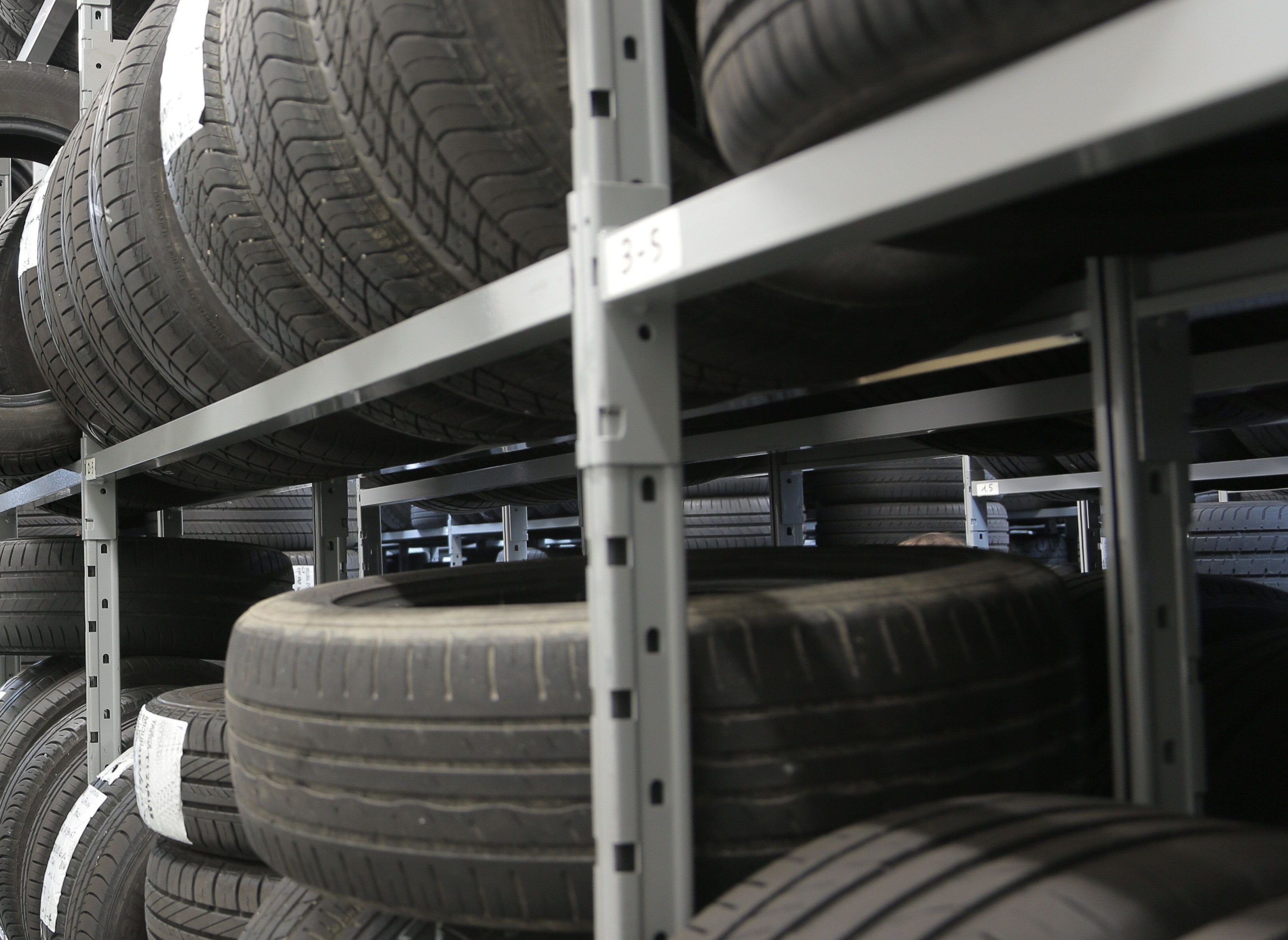 Tyres stacked on storage racks in a tyre retailer warehouse