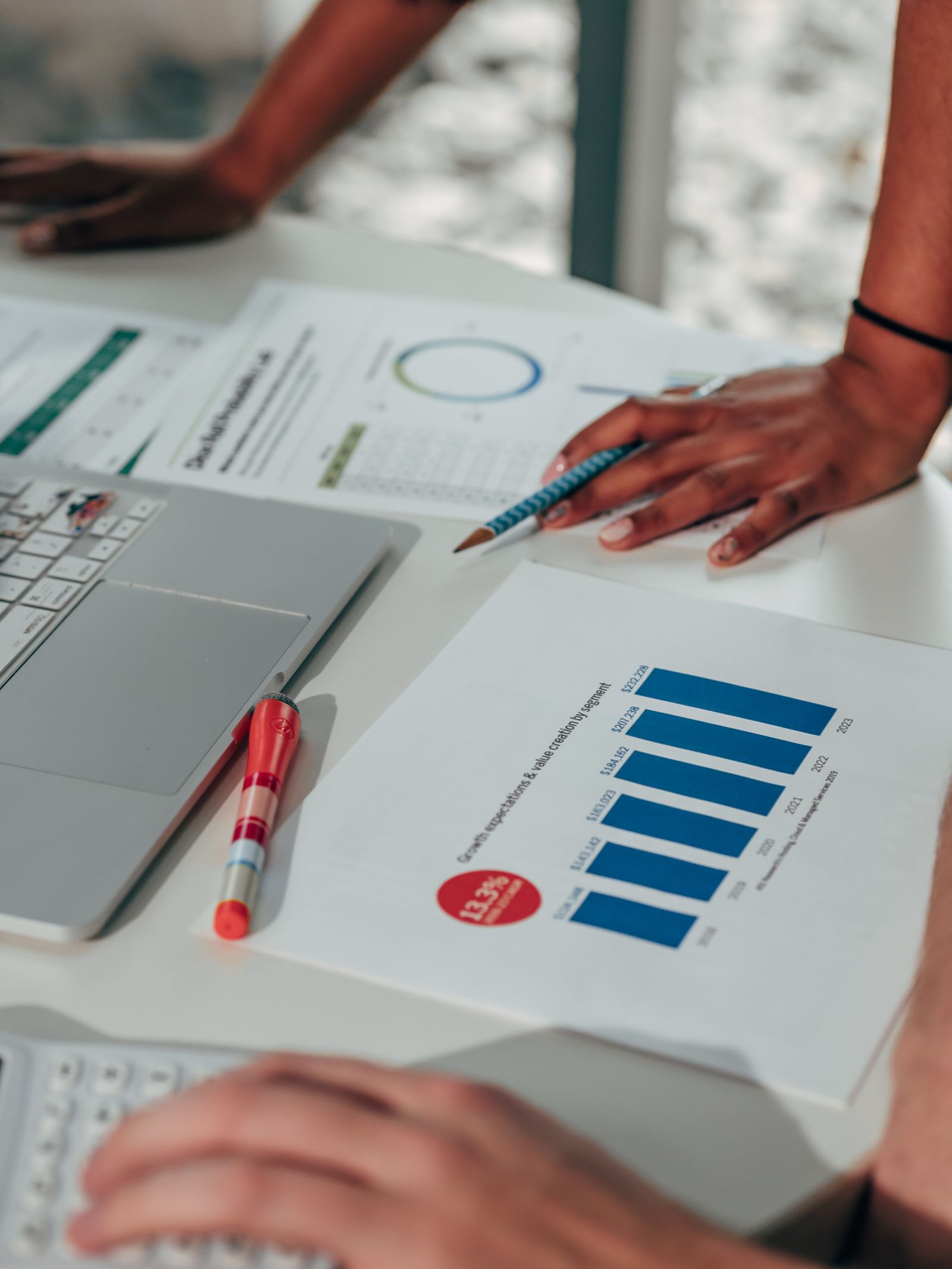 Team working with marketing data on laptops in an office