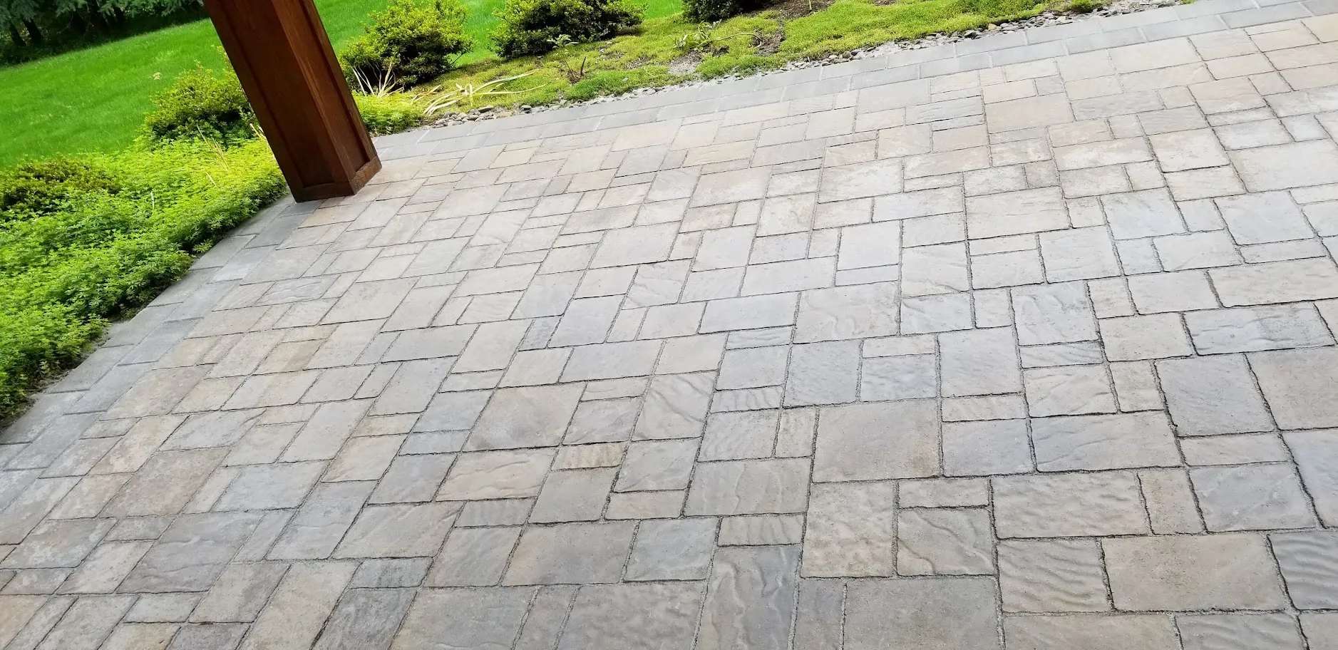 The same large paver patio after restoration, with the joints cleared and re-sanded and the stone color clean