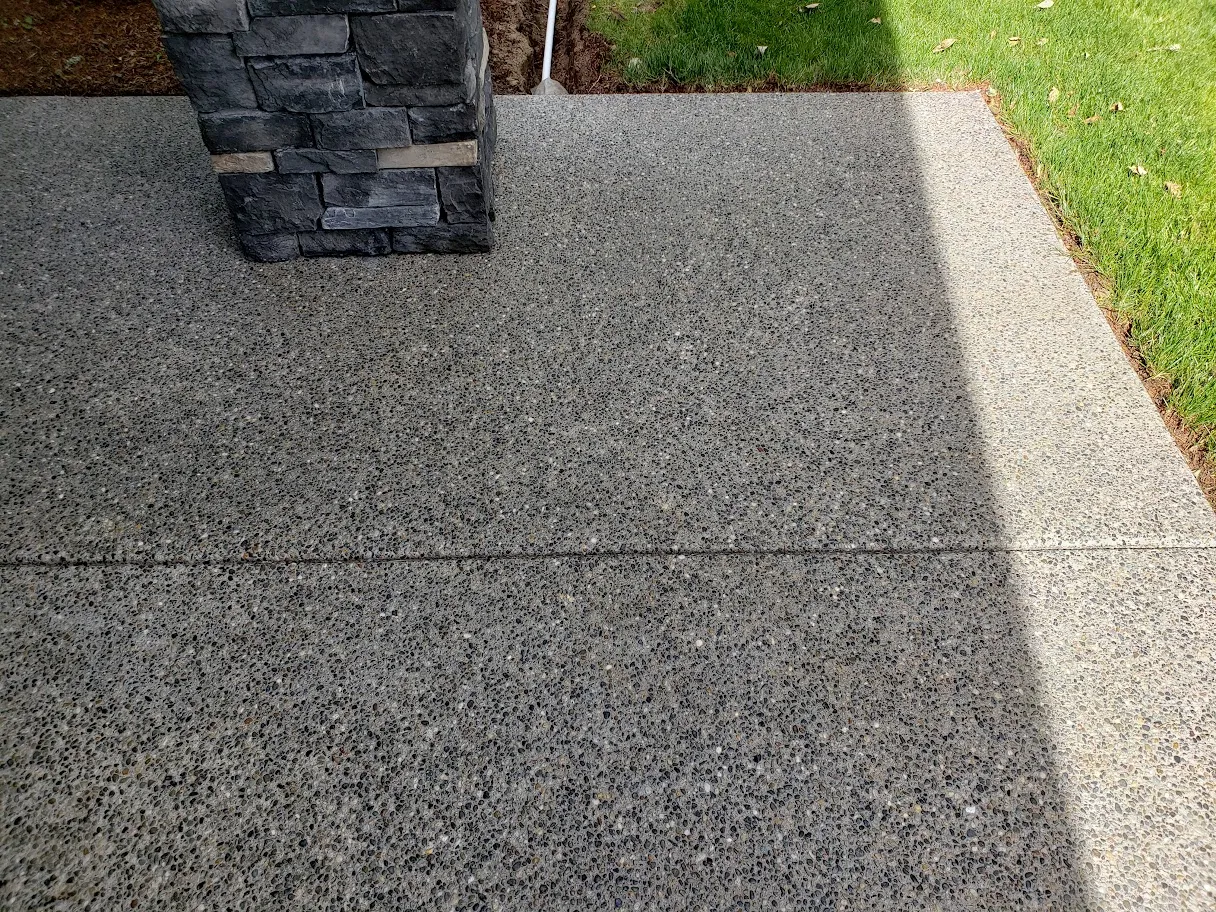 The same exposed aggregate walkway after restoration, with the stain removed and the aggregate showing deeper color and definition