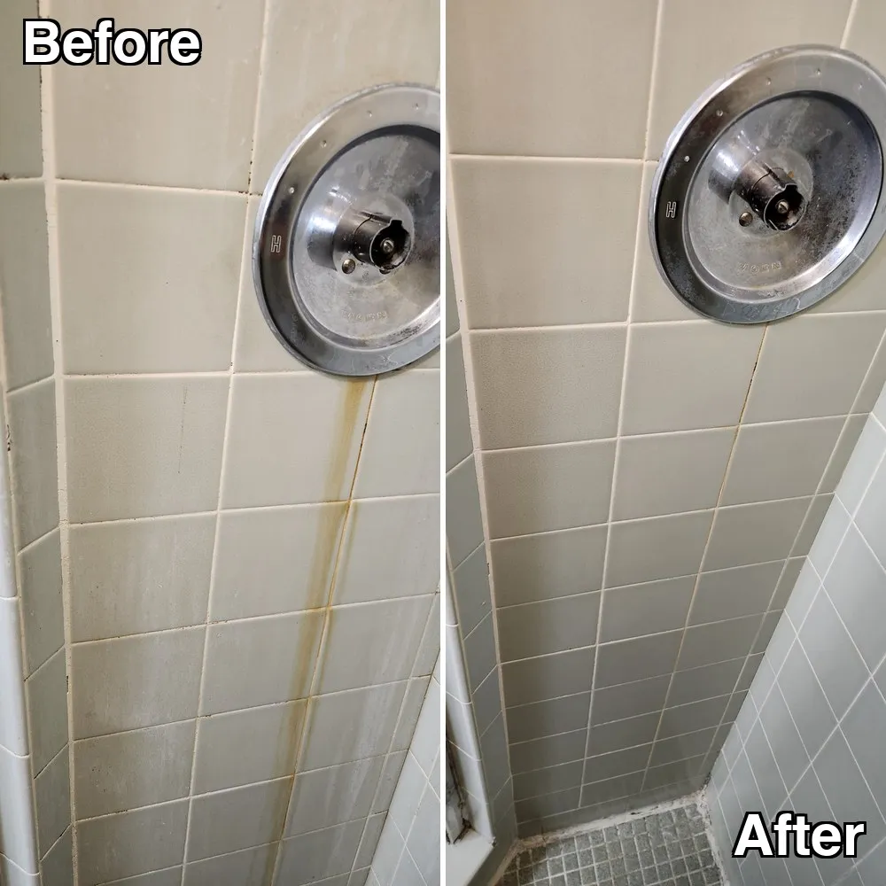 Before and after: a shower wall with a rust trail running below the valve, cleaned away to leave clean tile and grout
