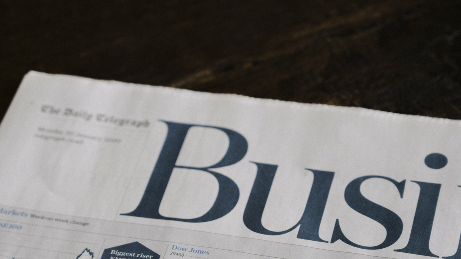 Folded newspaper open to the business section