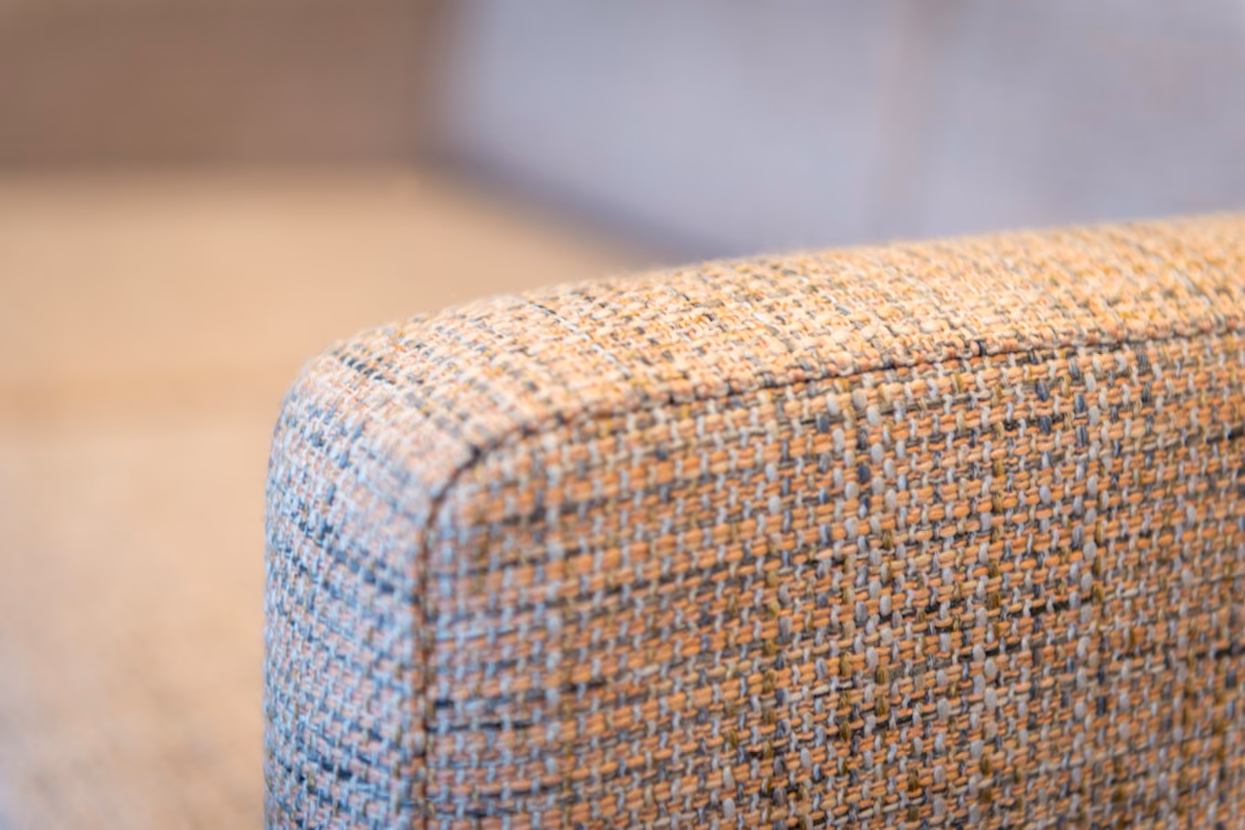Close-up of tweed upholstery texture on a waiting room chair