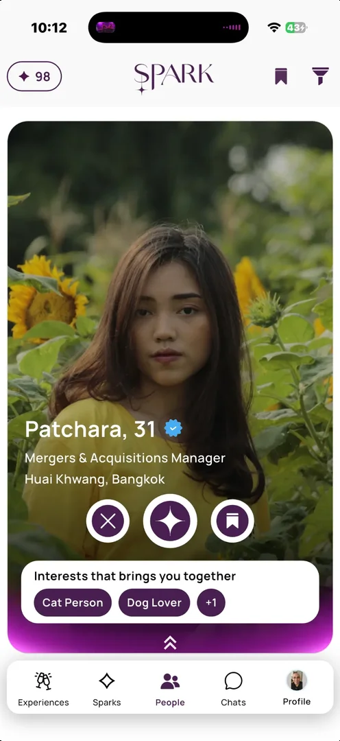 SPARK app — discovery view showing a verified member profile with shared interests