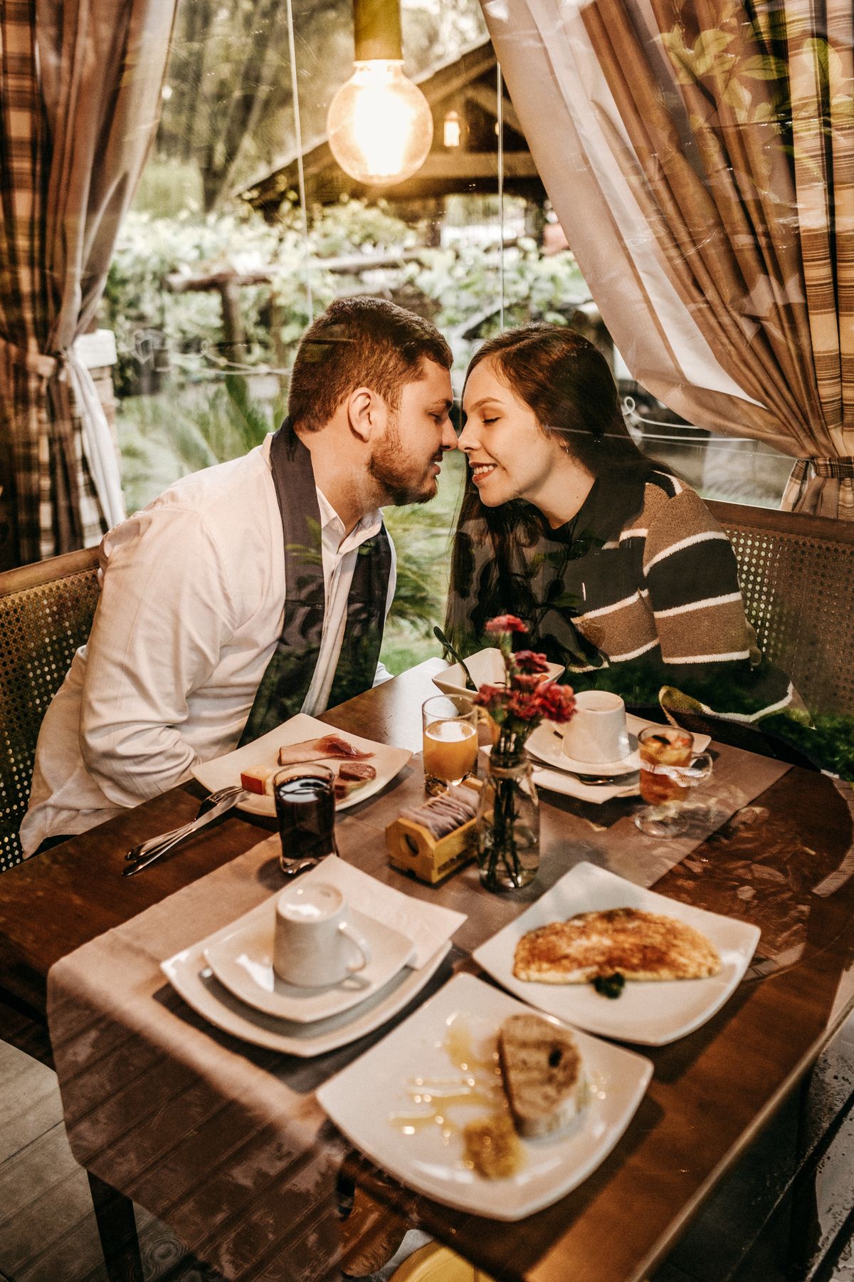 A man and woman facing each other across a dinner table