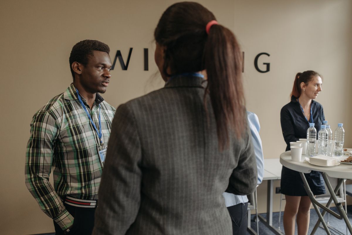 Professionals in conversation at an evening networking gathering
