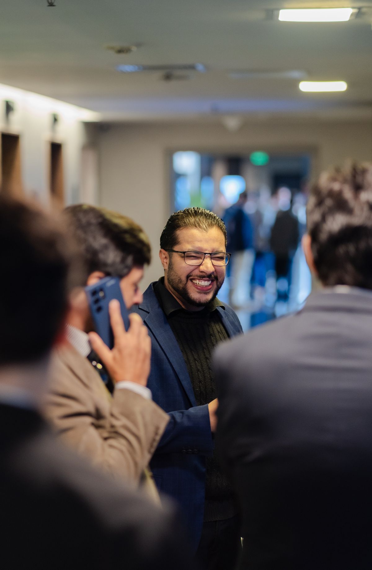 A small group of professionals talking at a networking event