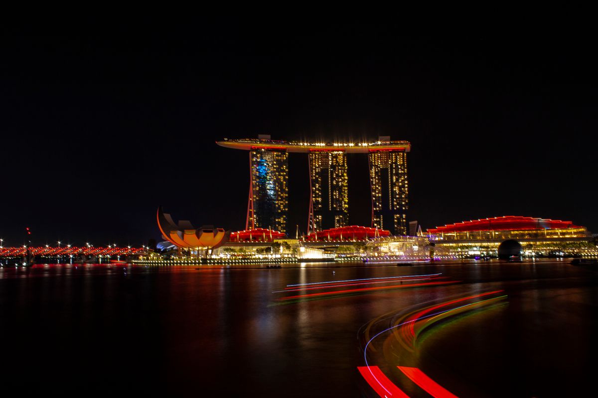 Marina Bay Sands lit up over the water at night