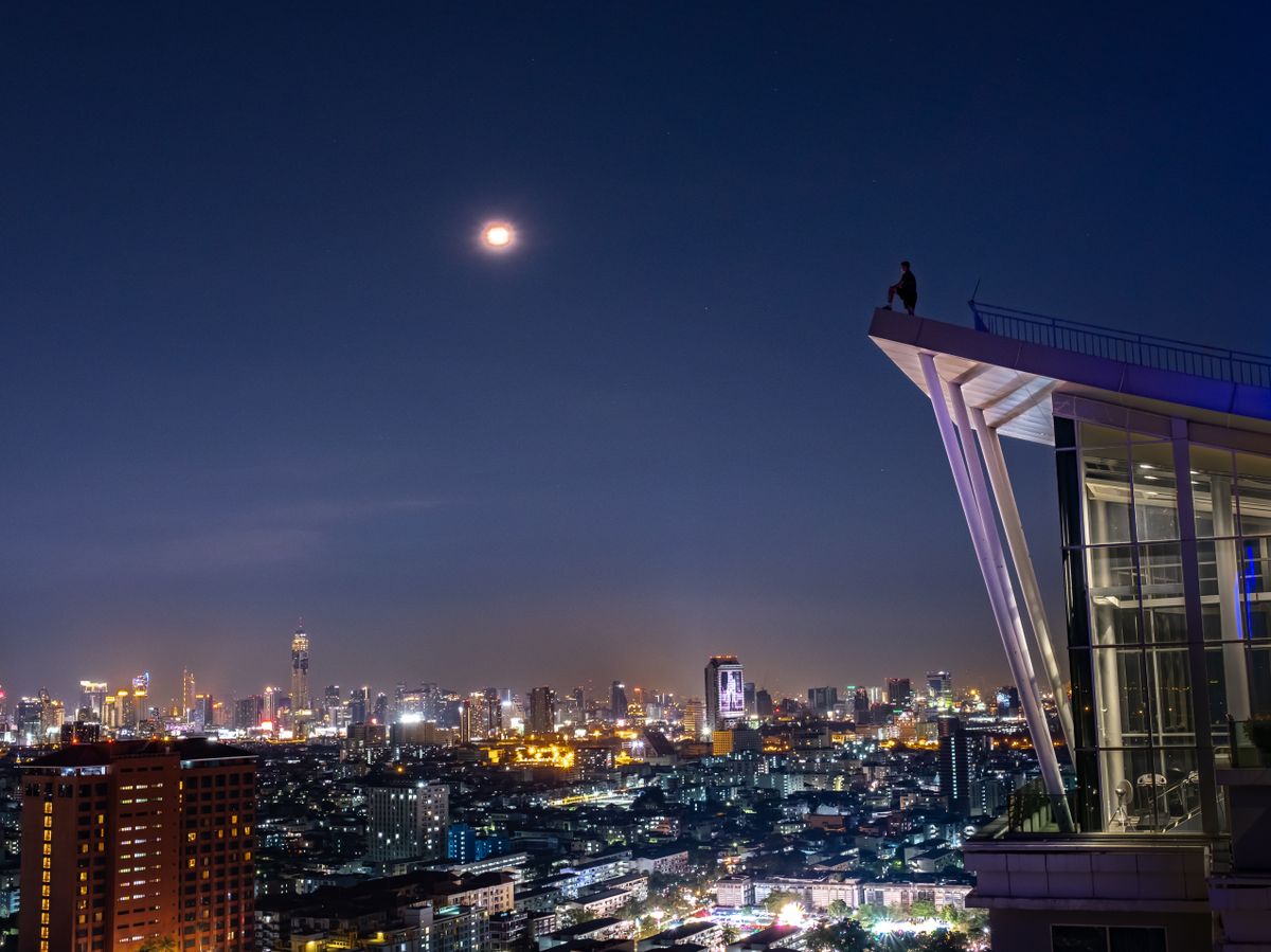Bangkok's skyline under a full moon