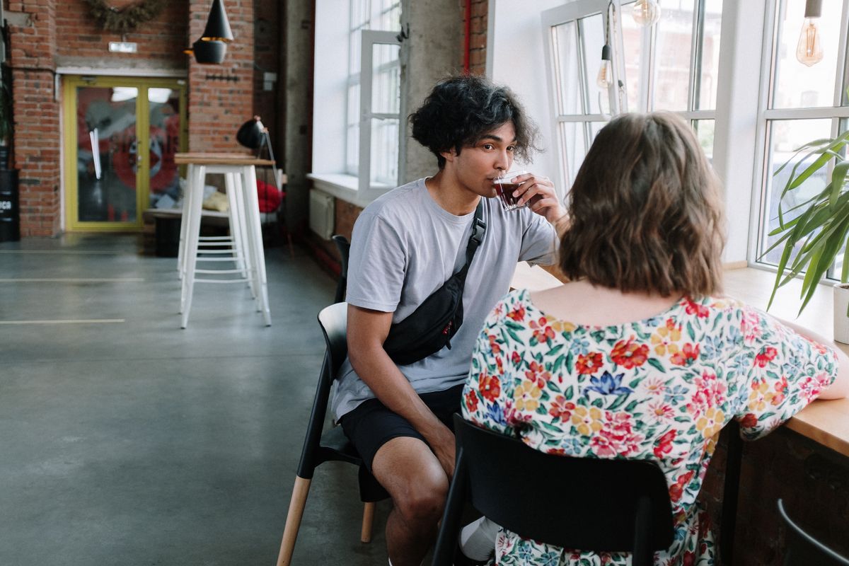 Young adults in relaxed conversation at an urban café