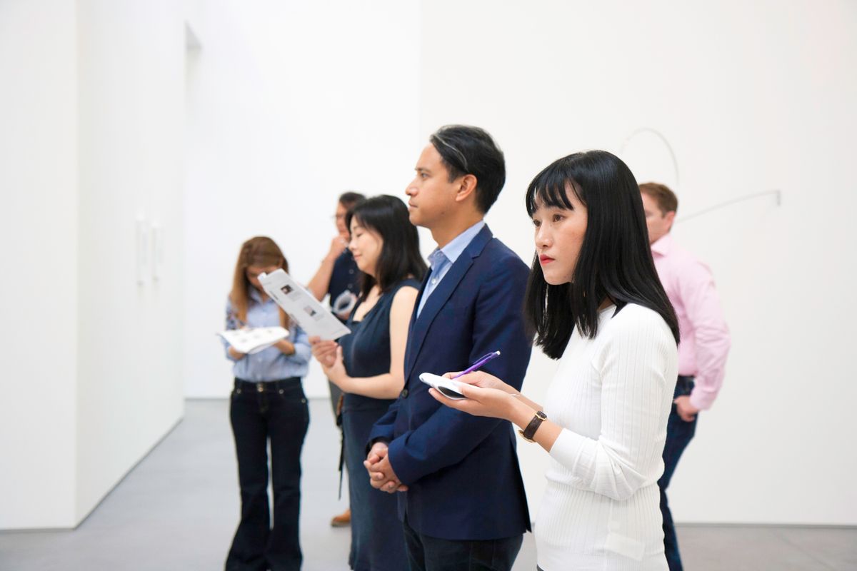 Visitors considering an installation in a modern gallery