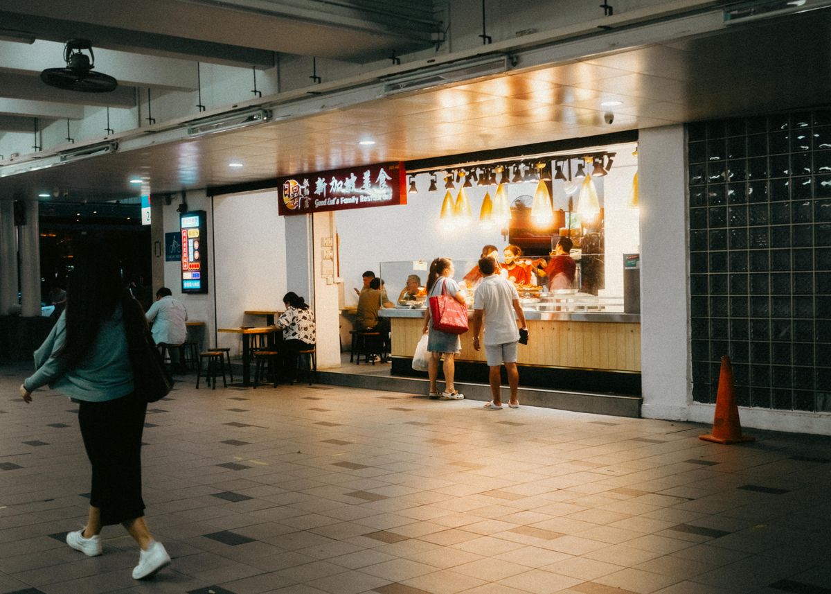 Street food tables filling a Singapore lane at night
