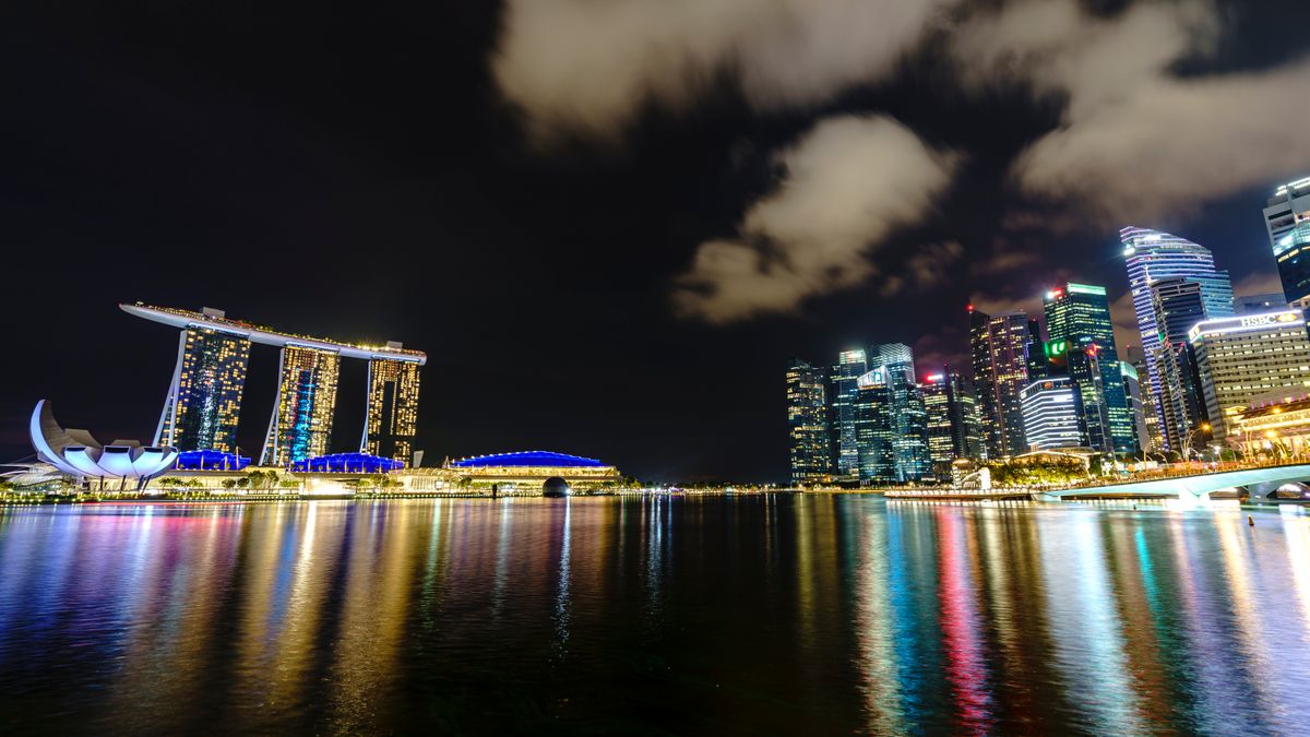 Marina Bay's skyline reflected in the water at night