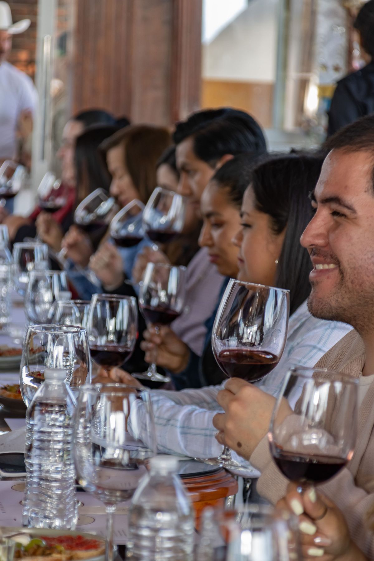 A group at a communal table during a wine tasting