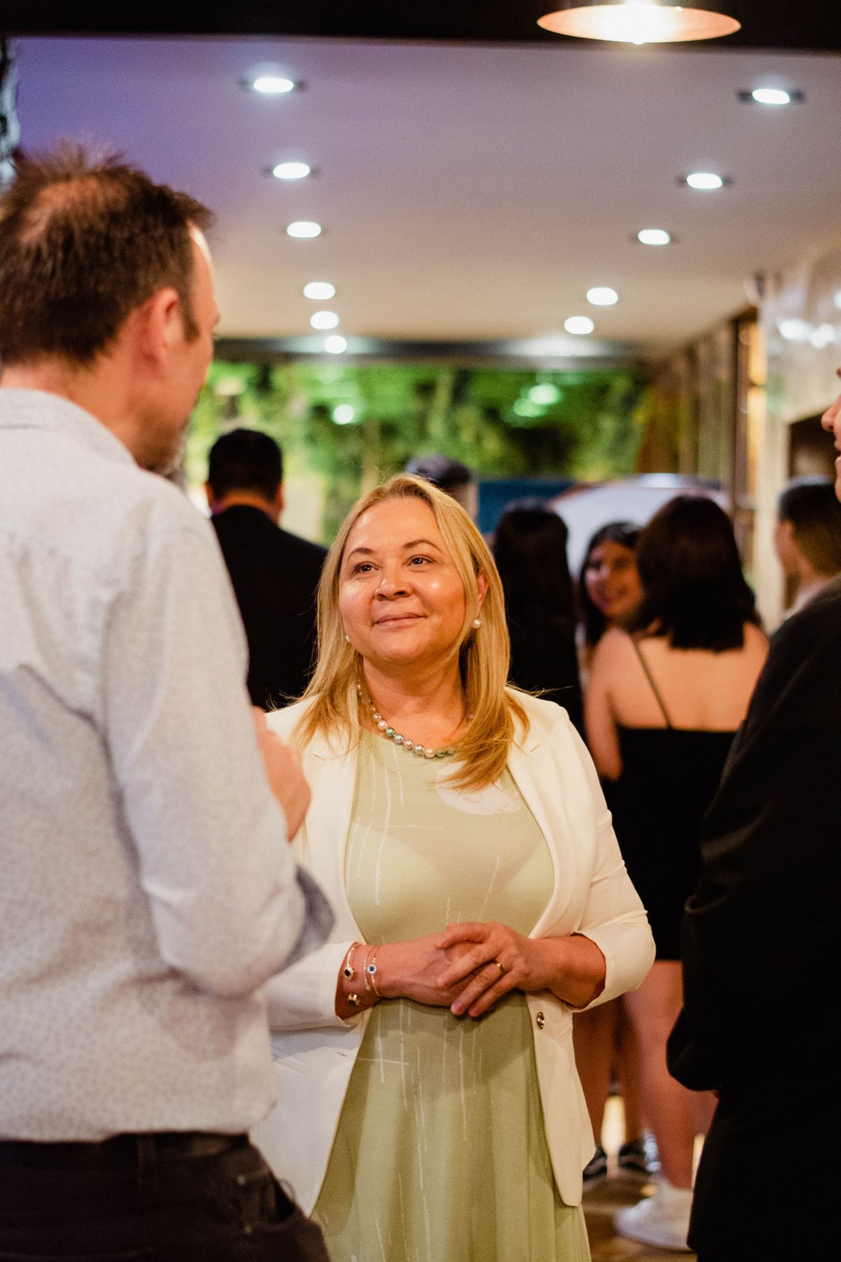 Guests mingling at a lively indoor gathering