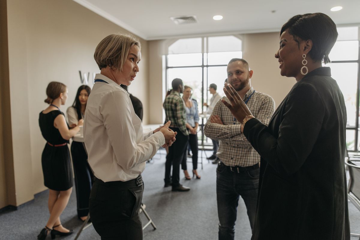 Professionals meeting at an indoor corporate event
