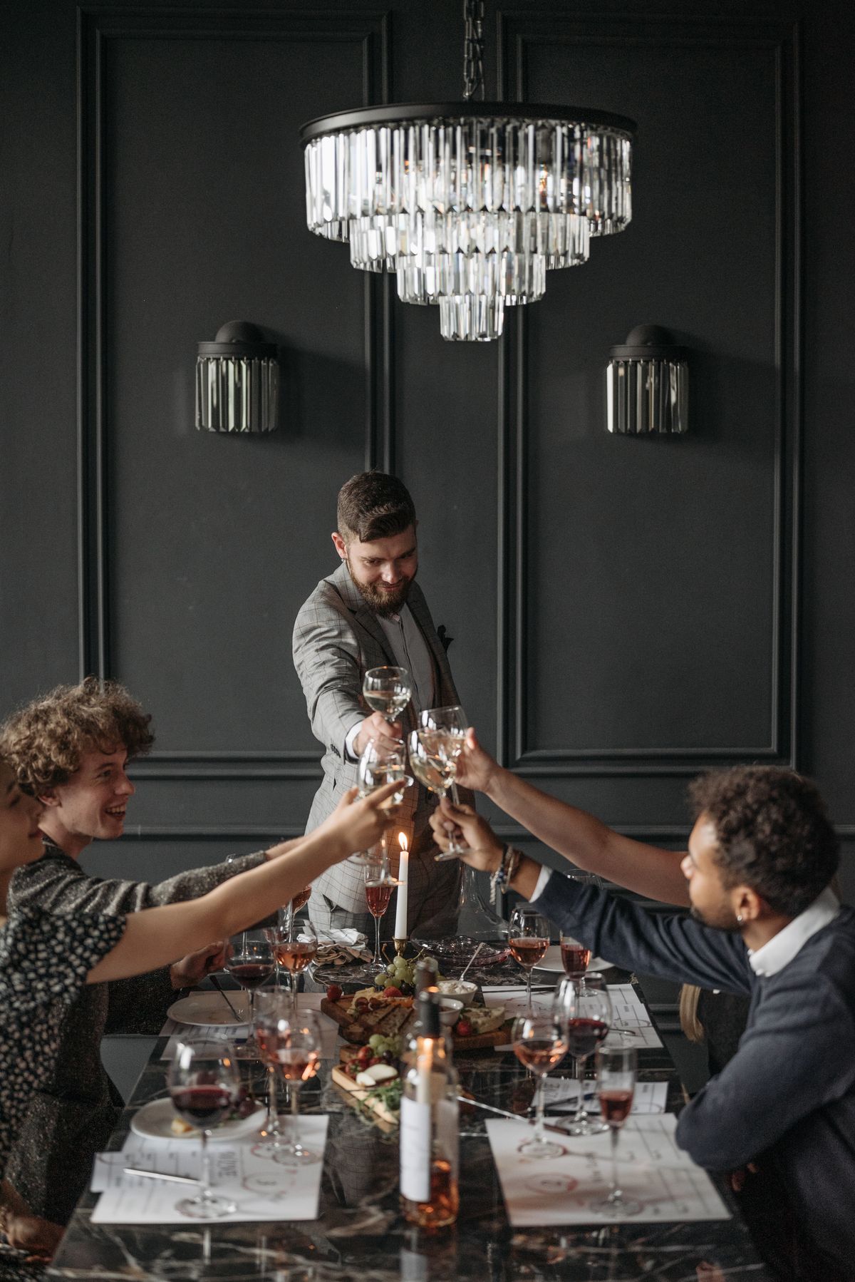 Guests toasting with wine at an elegant dinner