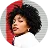 Portrait of a woman with curly hair wearing a white top against a white background.