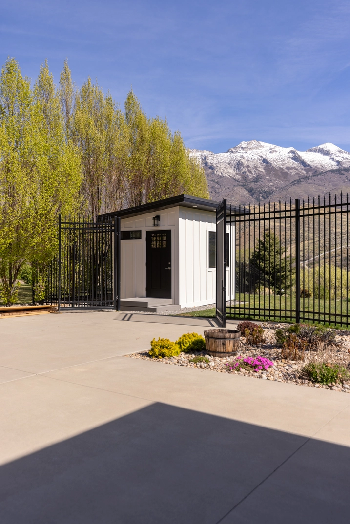 White outdoor sauna beside the pool area at the Custom Lehi residence