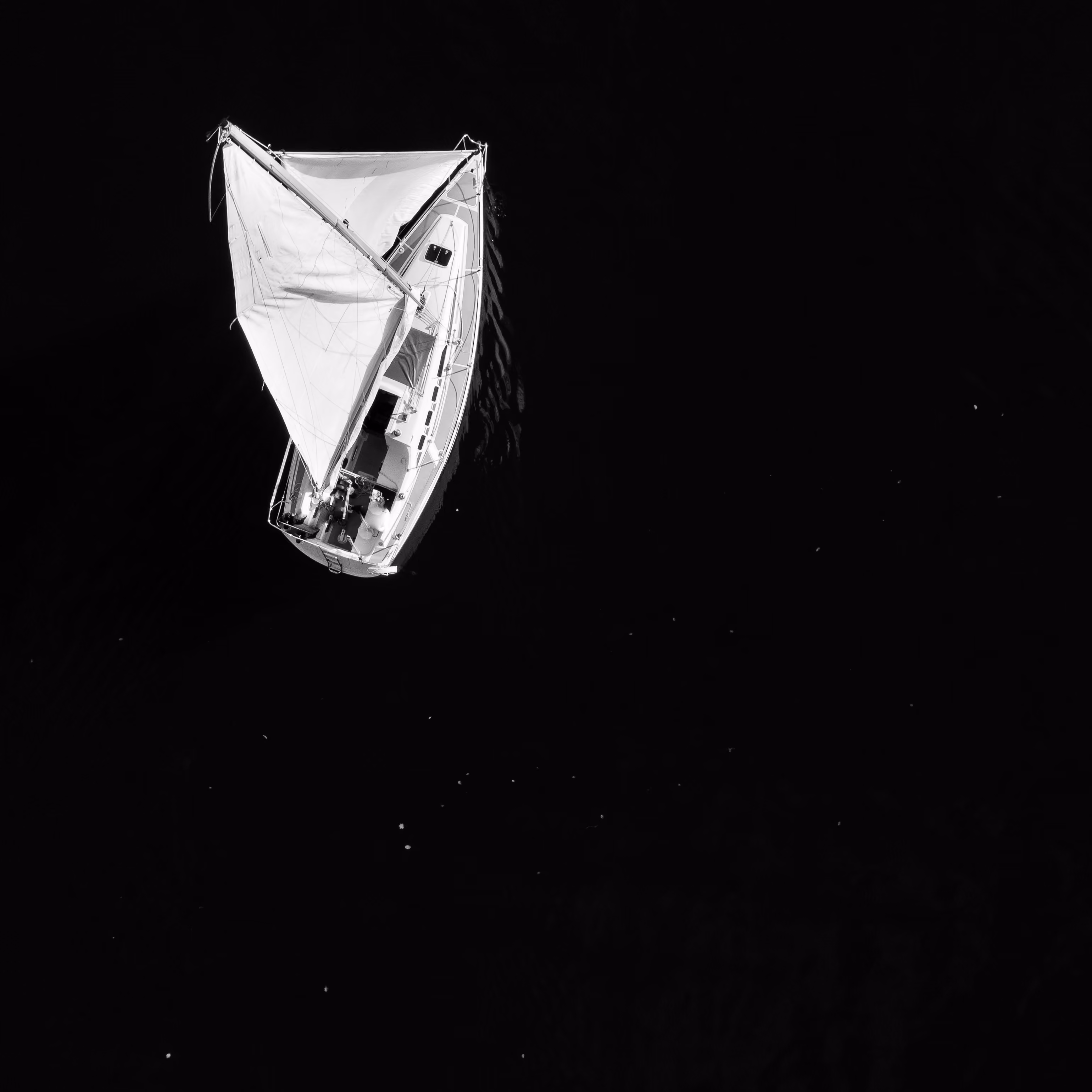 An image of the top view of the sailing boat on the sea.