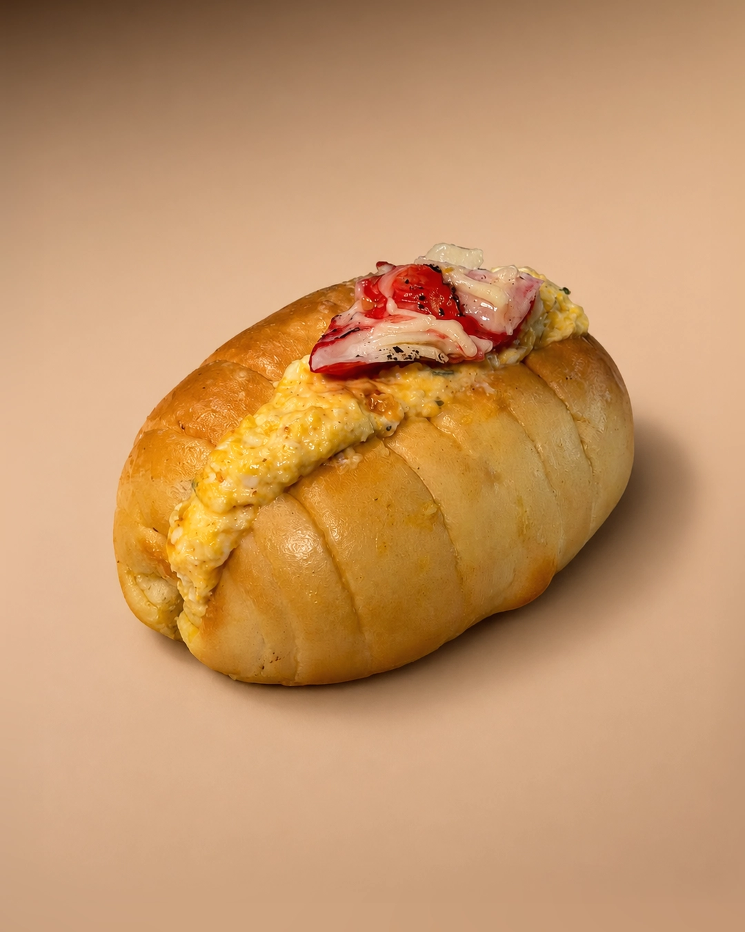 Crab stick and tamago salt bread, split and filled with soft egg, topped with shredded crab stick and cracked black pepper.