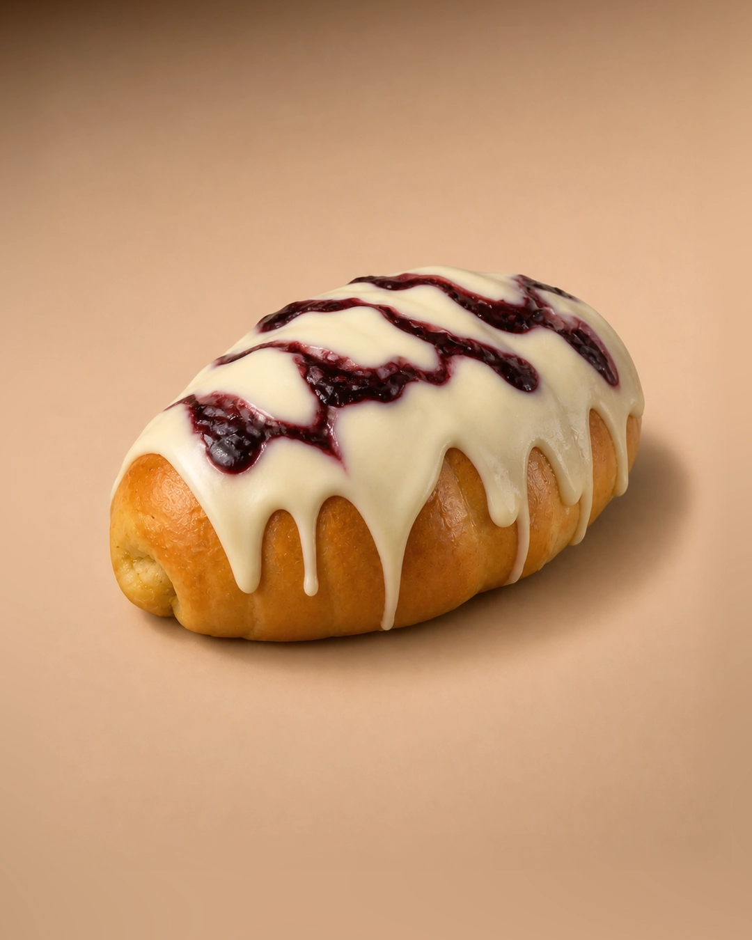 Cracking white chocolate and blueberry salt bread, coated in a thin white chocolate glaze that drips down the sides, with a zigzag of blueberry compote across the top.