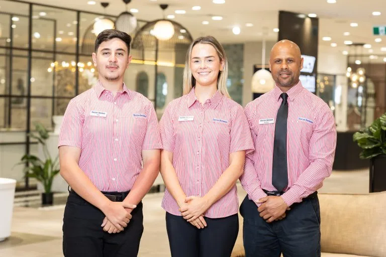 harvey norman group photo- striped red retail shirts