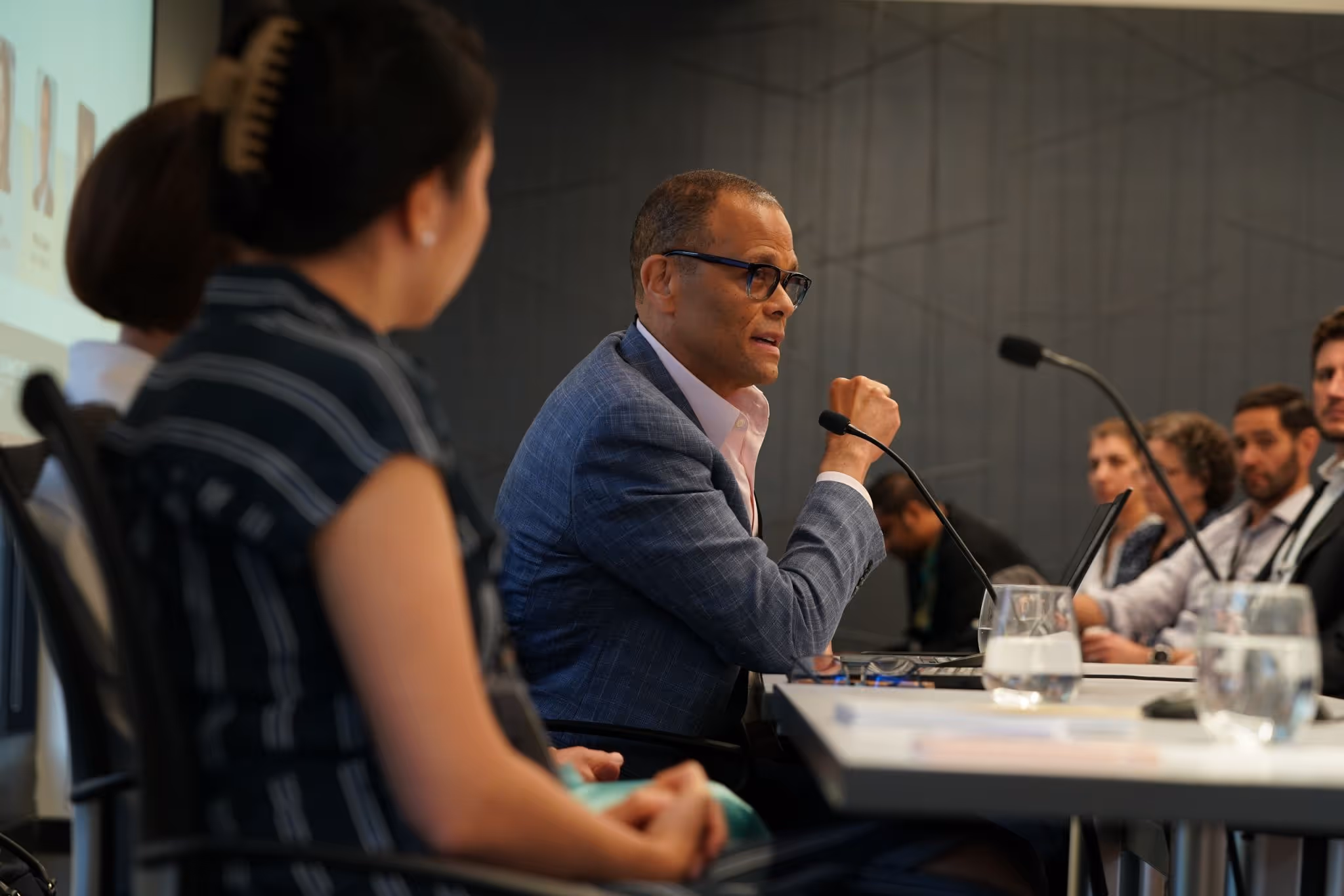 Philip Gaskin speaking at a panel surrounded by people