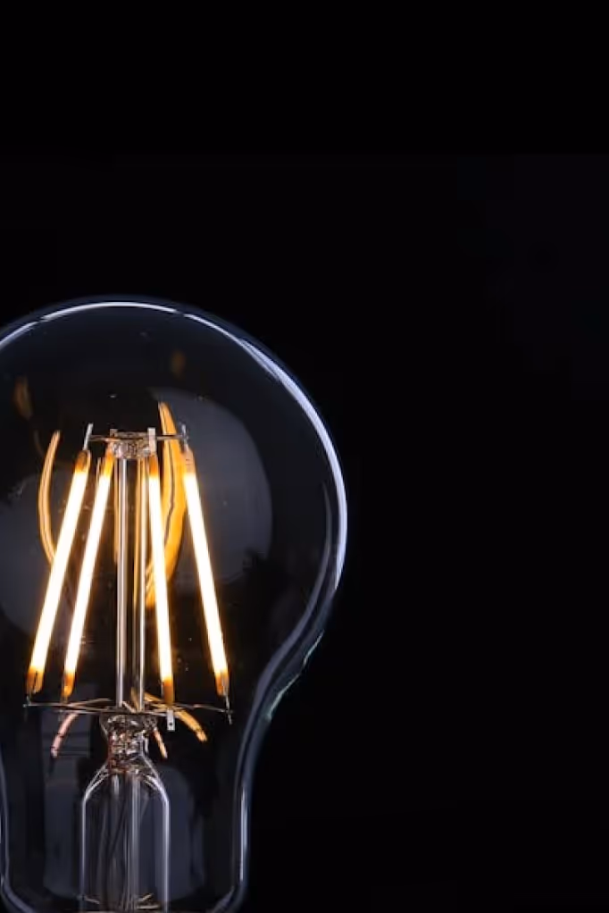lit lightbulb on a black background