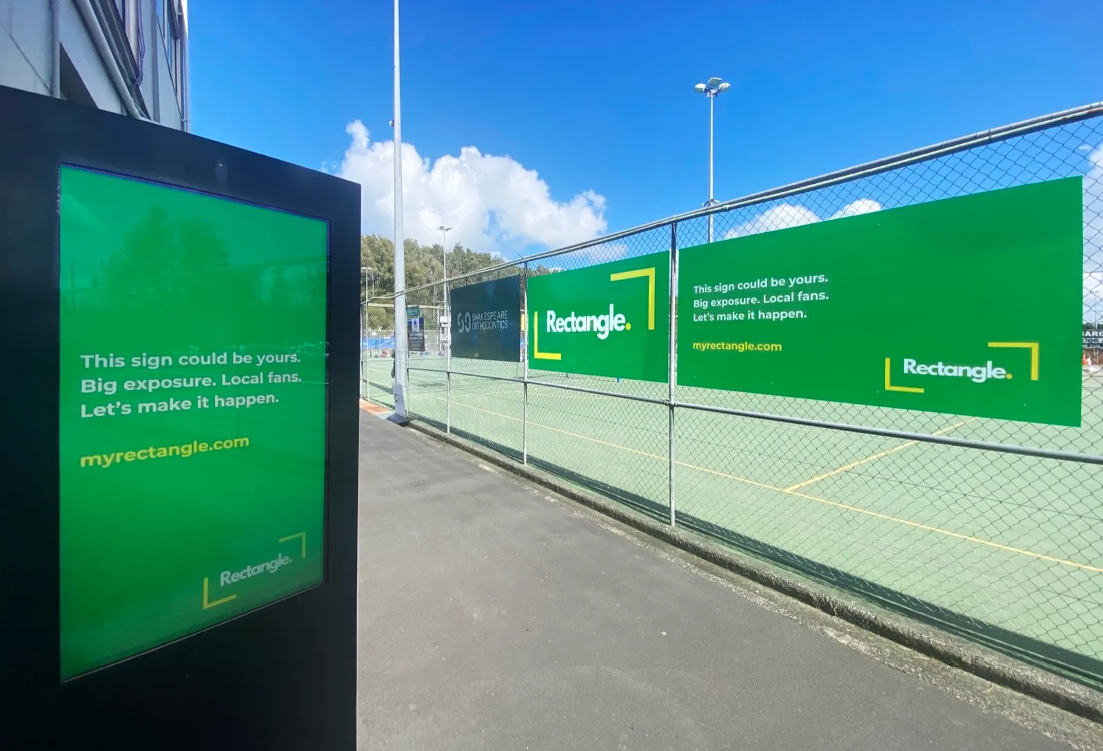 A Rectangle digital blade at the entrance to Netball North Harbour, with printed Rectangle banners along the court fence