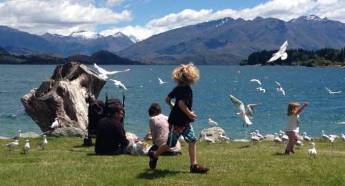Children playing by the waterfront in Wanaka.